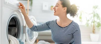 Woman setting washing machine